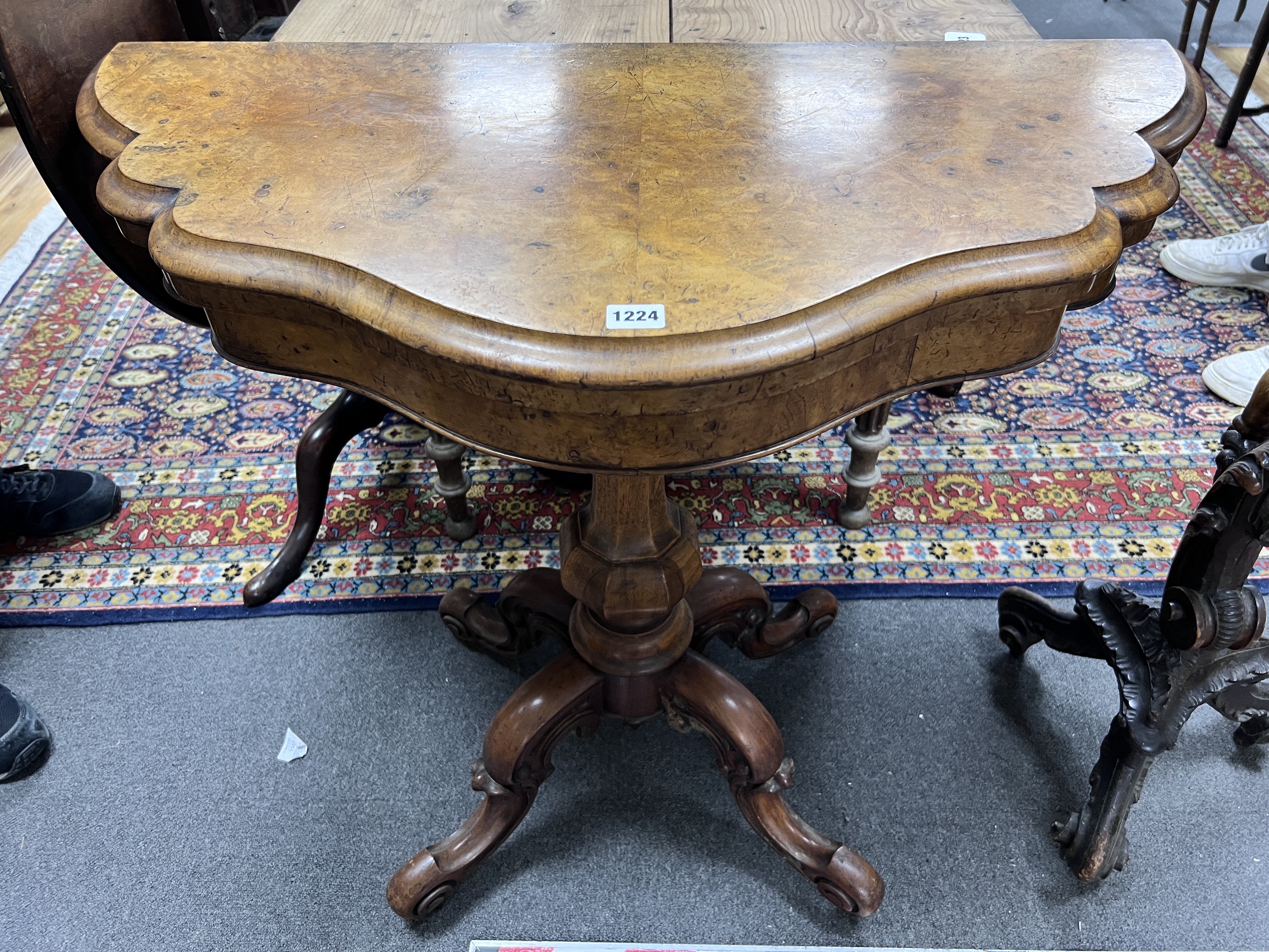 A Victorian walnut demi-lune folding tea table, width 91cm